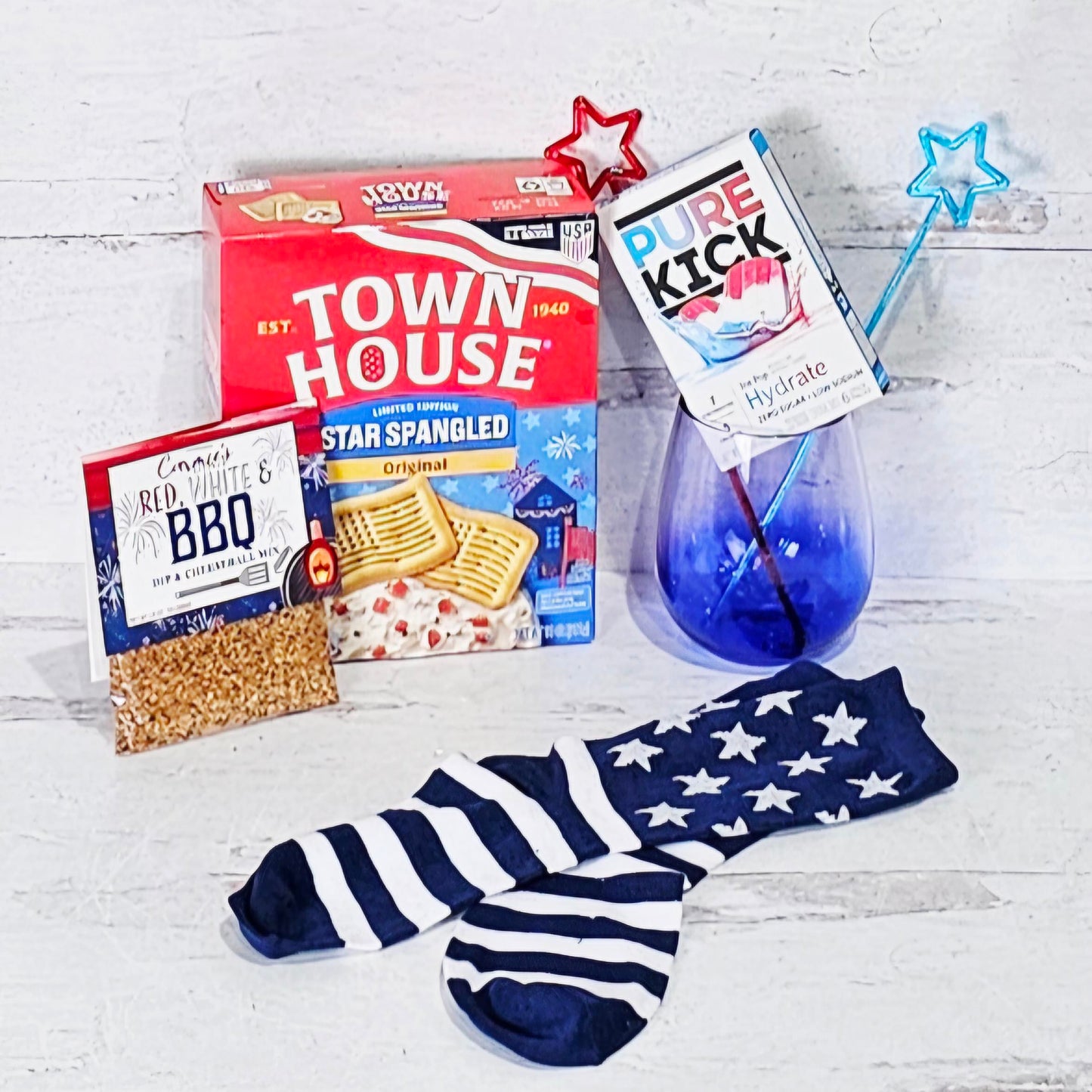 Collection of patriotic-themed products including Town House crackers, BBQ dip mix, and socks with American flag design. 